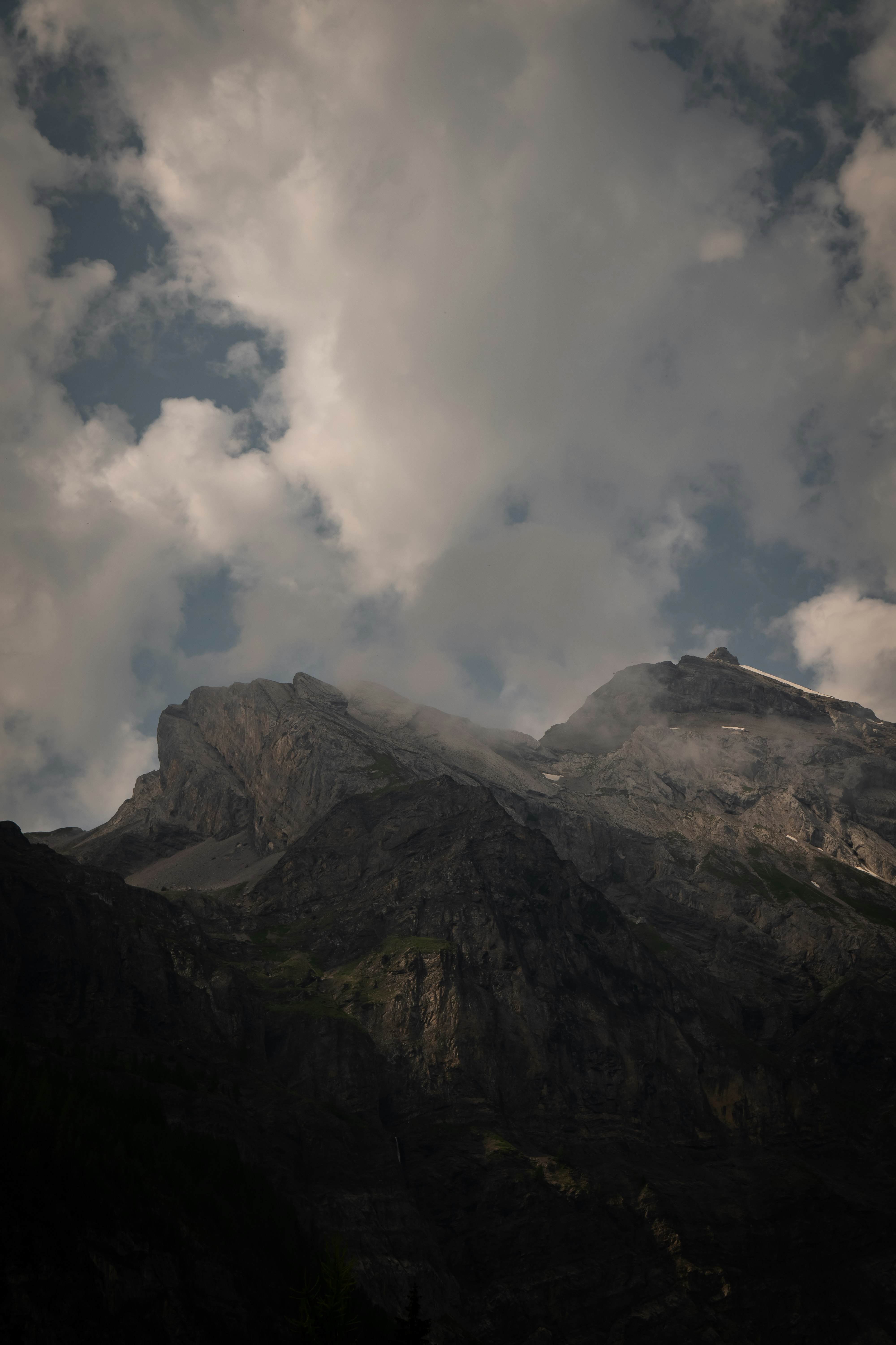 gray and black mountain under white clouds during daytime